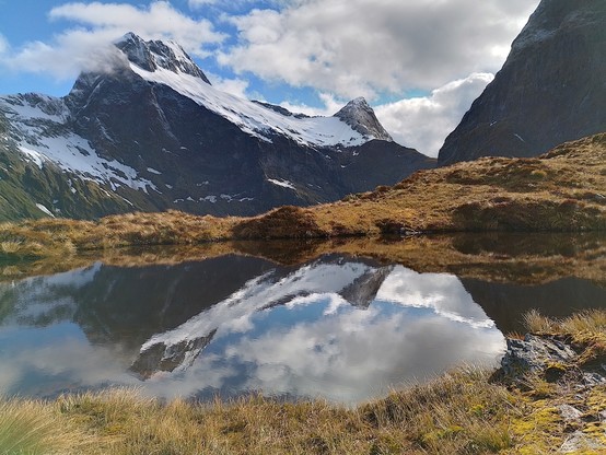 Tarn with reflections of the mountains from the top of Mackinnon Pass.