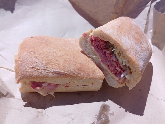 My New York Style sandwich with corned beef, sauerkraut, swiss cheese and probably other things. Whole pepper berries, too. Yum!